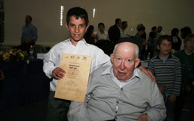 Bible scholar Amos Hakham with his grandson Nadav Hakham, after Nadav won the 2008 International Bible Quiz in Jerusalem. Amos Hakham, who won the first Bible Quiz in 1958, passed away on August 2, 2012. (photo credit: Gershon Elinson/ Flash90)