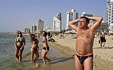 Organizers of the Go Topless march argue that these women have the same right to bare their chests in public as this man does. (photo credit: Serge Attal/Flash90)