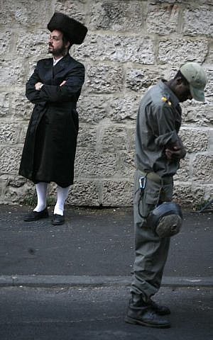 A Border Policeman and an ultra-Orthodox man in Jerusalem on Shabbat (Photo credit: Miriam Alster/ Flash 90)