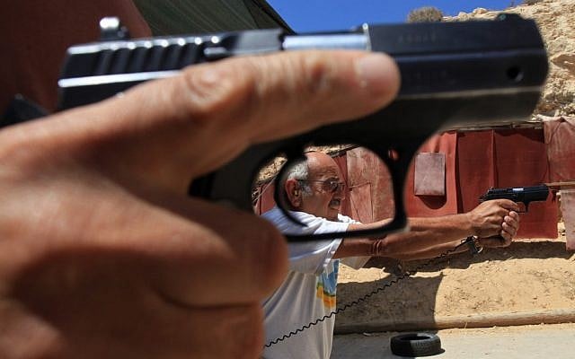 Illustrative: Man holding a handgun. (Nati Shohat/Flash90)
