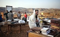 A settler prays at the Maoz Esther outpost in the West Bank (photo credit: Matanya Tausig/Flash90)