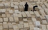 An ultra-Orthodox couple at a cemetery (illustrative photo credit: Nati Shohat/Flash90)