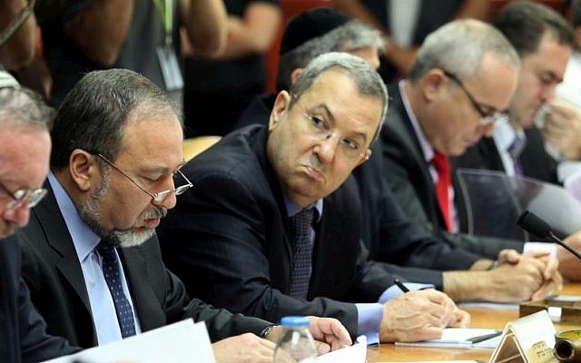 Then-defense minister Ehud Barak (holding pen) looks at then-foreign minister Avigdor Liberman (to his right) at a cabinet meeting led by then-premier Benjamin Netanyahu in 2010. (Amit Shabi/Pool/Flash90) Then-defense minister Ehud Barak (holding pen) looks at then-foreign minister Avigdor Liberman (to his right) at a cabinet meeting led by then-premier Benjamin Netanyahu in 2010. (Amit Shabi/Pool/Flash90)
