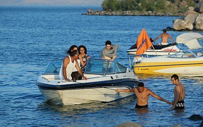 Tourists operate speedboats on the Sea of Galilee (photo credit: Moshe Shai/Flash90)