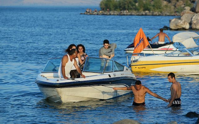 Tourists operate speedboats on the Sea of Galilee (photo credit: Moshe Shai/Flash90)