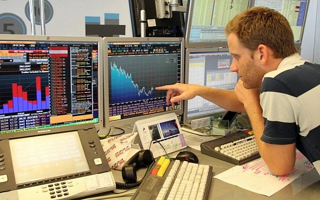 An investor checks out the action on the Tel Aviv Stock Exchange (Photo credit: Meir Partush/FLASH90) An investor checks out the action on the Tel Aviv Stock Exchange (Photo credit: Meir Partush/FLASH90)