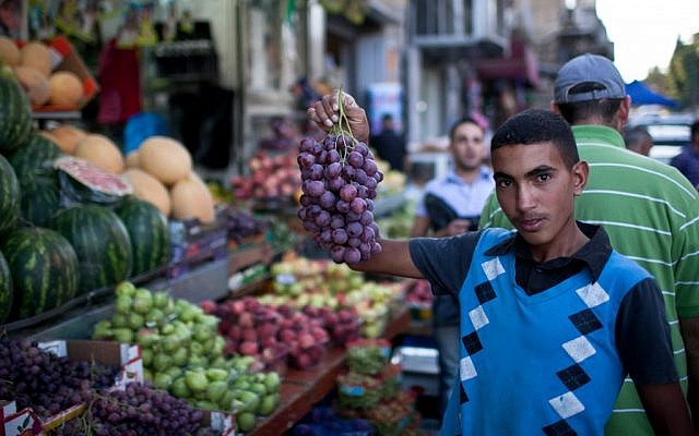 Illustrative: A Palestinian youth in Jerusalem displays his produce during Ramadan, July 24, 2012. (Noam Moskowitz/Flash90) Illustrative: A Palestinian youth in Jerusalem displays his produce during Ramadan, July 24, 2012. (Noam Moskowitz/Flash90)