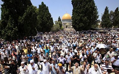 Palestinians pray outside the Al-Aqsa Mosque in Jerusalem (photo credit: Sliman Khader/Flash90/File)