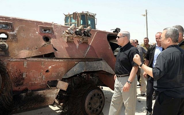 Prime Minister Benjamin Netanyahu, next to a burned out APC, and Defense Minister Ehud Barak, far right, at Kerem Shalom in the wake of the August 5 terror attack that left 16 Egyptian soldiers dead. (photo credit: Avi Ohayon/GPO/Flash90) Prime Minister Benjamin Netanyahu, next to a burned out APC, and Defense Minister Ehud Barak, far right, at Kerem Shalom in the wake of the August 5 terror attack that left 16 Egyptian soldiers dead. (photo credit: Avi Ohayon/GPO/Flash90)