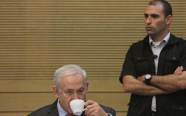 Bibi Netanyahu enjoys a rare quiet moment during the Knesset's meeting to review the state comptroller's report on the Carmel fire disaster (photo credit: Miriam Alster/FLASH90)