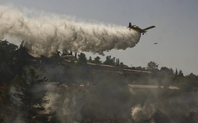 Firefighters work to extinguish a forest fire burning near Moshav Even Sapir. (photo credit: Oren Nahshon/Flash90) Firefighters work to extinguish a forest fire burning near Moshav Even Sapir. (photo credit: Oren Nahshon/Flash90)