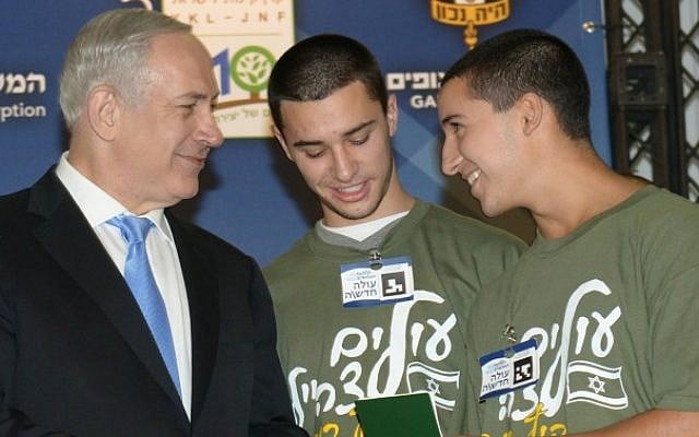 Prime Minister Benjamin Netanyahu presents Israeli identity cards to Barak and Ro'i Gaibel, one of five sets of twins that made aliya on Tuesday (photo credit: Amos Ben Gershom/GPO/Flash90) Prime Minister Benjamin Netanyahu presents Israeli identity cards to Barak and Ro'i Gaibel, one of five sets of twins that made aliya on Tuesday (photo credit: Amos Ben Gershom/GPO/Flash90)