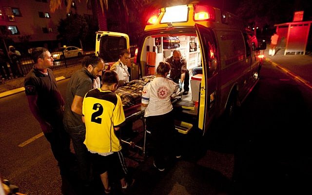 Paramedics at the scene of the hit and run in Netanya Friday night. (photo credit: Omer Messinger/Flash90)