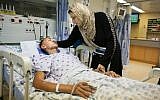 17-year-old Jamal Julani is visited by his mother at Hadassah Ein Kerem Hospital after being attacked by Jewish youths in downtown Jerusalem. (photo credit: Oren Nahshon/Flash90)