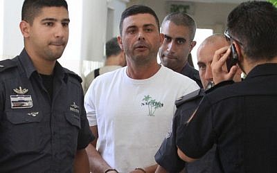 One of six suspects arrested for financing, developing and distributing "Green Energy", a drink made from illegal khat juice, at the Jerusalem Magistrate's Court on August 20, 2012. (photo credit: Yoav Dudkevitch/Flash90).