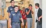 Police escorting suspects in the beating to court on Tuesday (photo credit: Oren Nahshon/Flash90)