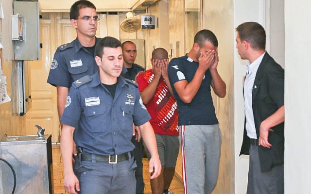Police escorting suspects in the beating to court on Tuesday (photo credit: Oren Nahshon/Flash90)