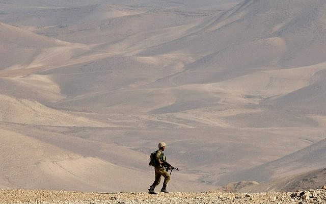A soldier trekking through the desert in June. (photo credit: Moshe Shai/Flash90)