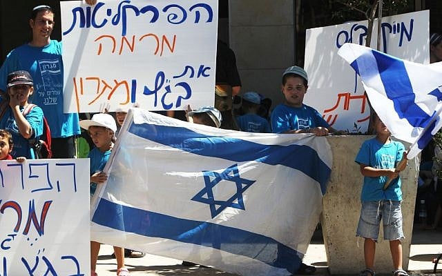 Residents of the West Bank outpost of Migron protesting the settlement's evacuation outside the Justice Ministry in Jerusalem on Thursday. (photo credit: Miriam Alster/Flash90)