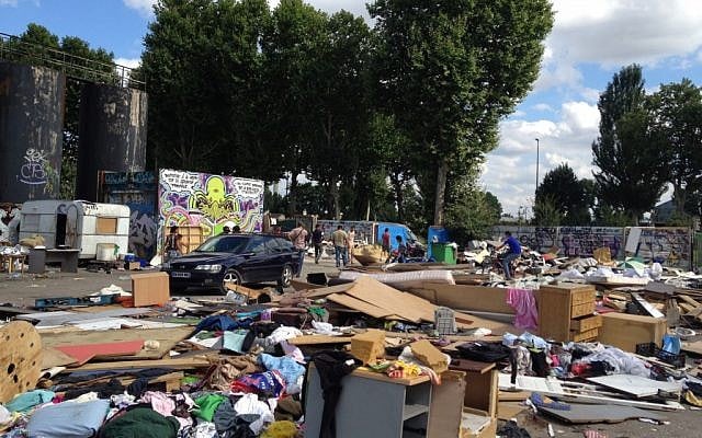 This is a Friday Aug. 10, 2012. file photo of a Roma encampment is set up near a highway in Clamart, west of Paris, Police officers on Thursday shut down encampments used by Roma or Gypsies, in Paris and in the northern city of Villeneuve d'Ascq. (Photo credit: AP/Michel Euler, File)