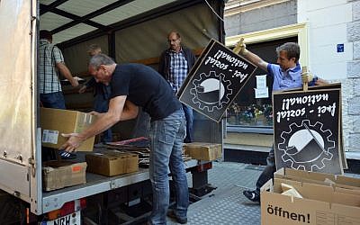 Police in plain clothes load into a vehicle items which they found in an apartment-sharing community of alleged neo-Nazis in Dortmund, Germany, Wednesday (AP/dapd, Sascha Schuermann)