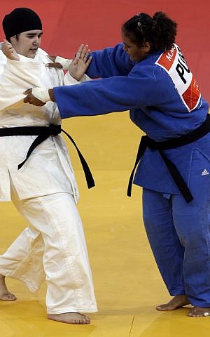Saudi Arabia's Wojdan Shahrkani and Puerto Rico's Melissa Mojica compete during the women's 78-kg judo competition at the 2012 Summer Olympics, Friday, Aug. 3 (photo credit:AP/Mike Groll) Saudi Arabia's Wojdan Shahrkani and Puerto Rico's Melissa Mojica compete during the women's 78-kg judo competition at the 2012 Summer Olympics, Friday, Aug. 3 (photo credit:AP/Mike Groll)