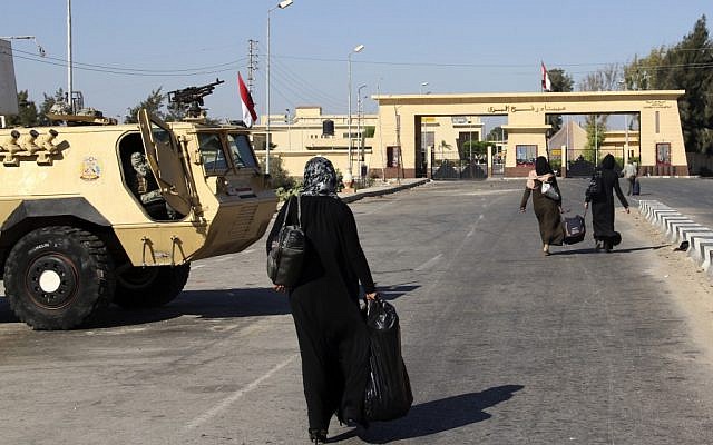 Palestinians walk toward the Rafah border crossing. (photo credit: AP Photo)