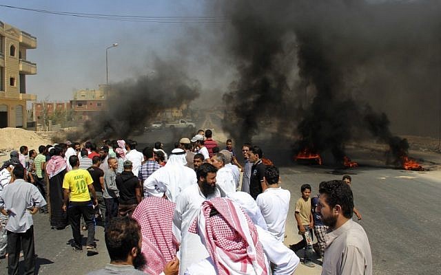 Residents of the Egyptian town of Rafah protest Monday against the killing of 16 Egyptian troops in a terror attack the previous night. (photo credit:AP Photo) Residents of the Egyptian town of Rafah protest Monday against the killing of 16 Egyptian troops in a terror attack the previous night. (photo credit:AP Photo)