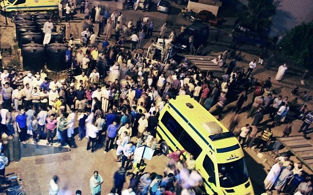 Egyptians stand outside the El Arish hospital Sunday night. (photo credit: AP)