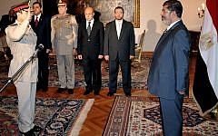 Egyptian President Mohammed Morsi, right, swears in newly-appointed Minister of Defense, Lt. Gen. Abdel-Fattah el-Sissi, in Cairo on Sunday, Aug. 12, 2012. (photo credit: Egyptian Presidency/AP)