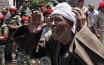An Egyptian man mourns during the funeral of 16 slain soldiers in Cairo Tuesday (photo credit: AP Photo/Thomas Hartwell)