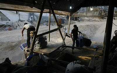 In this Saturday, May 28, 2011 file photo, Palestinians smuggle goods used for construction through a tunnel from Egypt to the Gaza Strip in Rafah, southern Gaza Strip. Hamas had hoped the Islamists who took charge in Egypt this summer -- fellow members of the region's Muslim Brotherhood -- would swiftly turn their shared border crossing into a free-flowing trade route, ending Gaza's five-year isolation from the world and making the tunnels obsolete. (AP Photo /Eyad Baba, File)