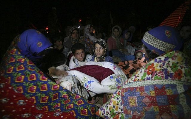 Residents spend the night outside their homes after an earthquake in the city of Varzaqan in northwestern Iran, on Saturday, Aug. 11 (photo credit: AP/Mehr News Agency, Ali Hamed Haghdoust)