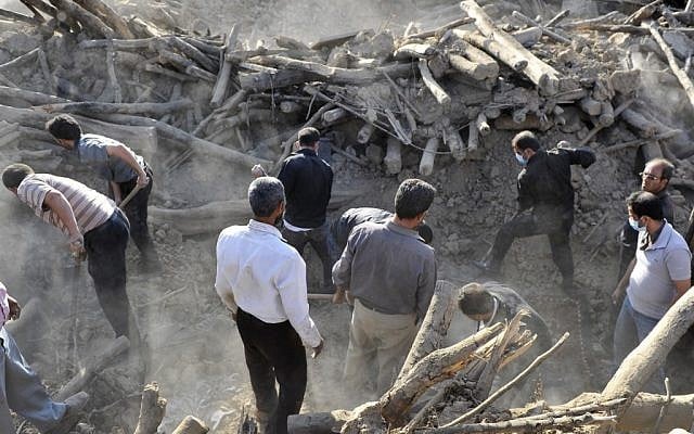 Iranians search the ruins of buildings at the village of Bajebaj near the city of Varzaqan in northwestern Iran, on Sunday, Aug. 12, 2012, after Saturday's earthquake. Twin earthquakes in Iran have killed at least 250 people and injured over 2,000, Iranian state television said on Sunday. (photo credit: AP/ISNA, Arash Khamoushi) Iranians search the ruins of buildings at the village of Bajebaj near the city of Varzaqan in northwestern Iran, on Sunday, Aug. 12, 2012, after Saturday's earthquake. Twin earthquakes in Iran have killed at least 250 people and injured over 2,000, Iranian state television said on Sunday. (photo credit: AP/ISNA, Arash Khamoushi)