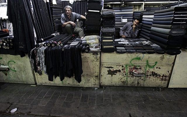 Textile merchants wait for customers in Tehran's old main bazaar on Saturday, July 14, 2012. (Vahid Salemi/AP)