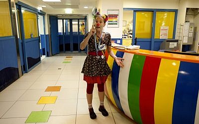 A Dream Doctors medical clown speaks on the phone at a medical center in central Israel, Tuesday, July 24, 2012 . (photo credit: AP/Ariel Schalit)