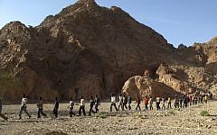 Dozens of African migrants cross into southern Israel through the border with Egypt in 2010. (photo credit: AP/Assaf Golan)