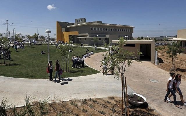 Israeli high-school students walk through the yard next to a new rocket-proof school building in the Shaar Hanegev Regional Council (photo credit: AP/Tsafrir Abayov/File)