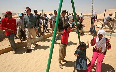 Canadian Foreign Affairs Minister John Baird, second left, visits Zaatari camp for Syrian refugees, in Mafraq, Jordan. (photo credit: AP)