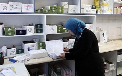 A female worker at the Ramallah Hospital pharmacy in the West Bank city of Ramallah. (AP Photo/Nasser Shiyoukhi)