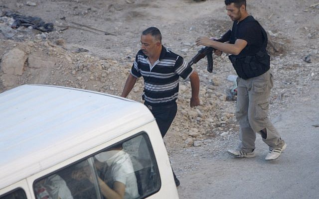 A Syrian rebel detains a man at an improvised checkpoint in a suburb of Damascus August 2 (photo credit: AP) A Syrian rebel detains a man at an improvised checkpoint in a suburb of Damascus August 2 (photo credit: AP)