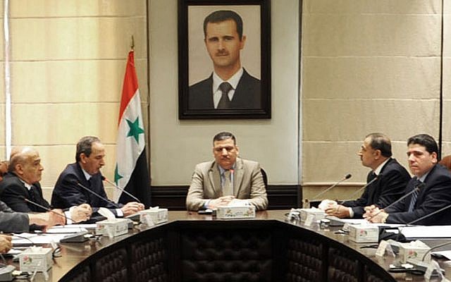 Riad Hijab heads a Syrian government meeting in an undated photo (photo credit: AP Photo/SANA)