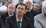 Illustrative: Syrian President Bashar Assad performs Eid prayers in the Hamad Mosque in Damascus, August 19 (photo credit: AP Photo/SANA)