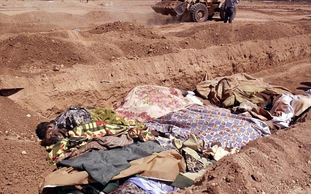 A citizen journalism image purports to show people killed by pro-government militiamen being buried in a mass grave in outside Damascus. (photo credit: AP Photo/Shaam News Network, SNN)