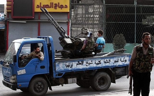 Free Syrian Army soldiers are seen at the border town of Azaz, some 20 miles (32 kilometers) north of Aleppo, on Sunday, July 29. (photo credit: Turkpix/AP) Free Syrian Army soldiers are seen at the border town of Azaz, some 20 miles (32 kilometers) north of Aleppo, on Sunday, July 29. (photo credit: Turkpix/AP)