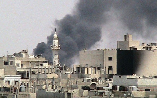 Smoke rising in Homs, Syria in 2012 (AP/Shaam News Network) Smoke rising in Homs, Syria in 2012 (AP/Shaam News Network)