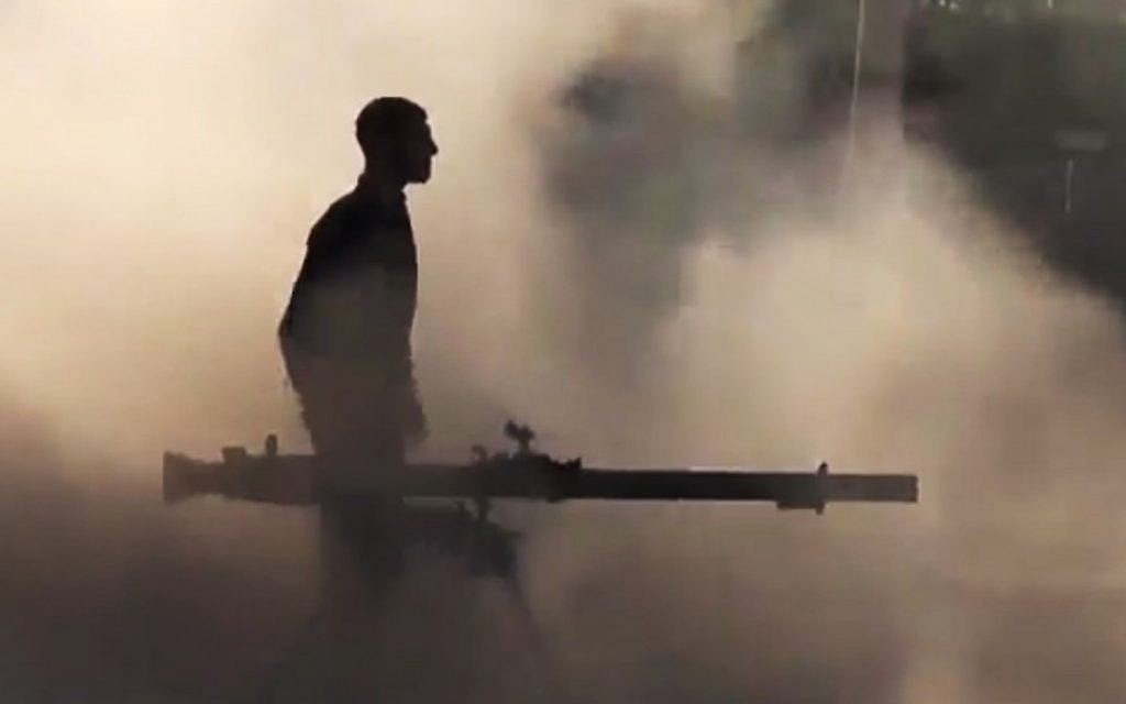 A Free Syrian Army soldier after firing a recoilless rifle during clashes with Syrian government forces in the village of Mukhtariya in the suburbs of Homs, Syria. (photo credit: Syrian Observatory for Human Rights via AP video)