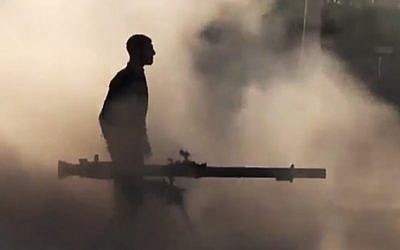 A Free Syrian Army soldier after firing a recoilless rifle during clashes with Syrian government forces in the village of Mukhtariya in the suburbs of Homs, Syria. (photo credit: Syrian Observatory for Human Rights via AP video)