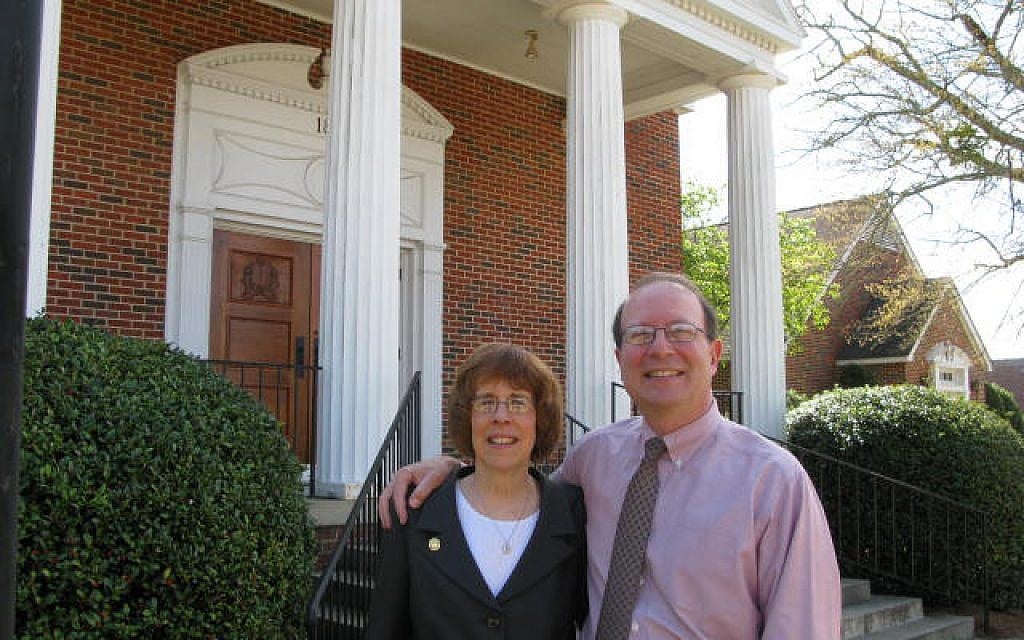 Rabbi Lynne Goldsmith and her husband, Rob Goldsmith, in front of their synagogue in Dothan, Alabama, where Jews can receive up to $50,000 for relocating there for at least five years. (Rob Goldsmith/JTA)