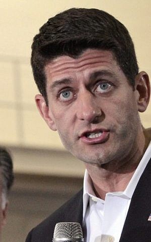 Republican presidential candidate Mitt Romney, left, listens as vice presidential running mate Rep. Paul Ryan, R-Wis., speaks at a rally at the Randolph Macon college in Ashland, Virginia, Saturday. (photo credit: AP/Mary Altaffer)